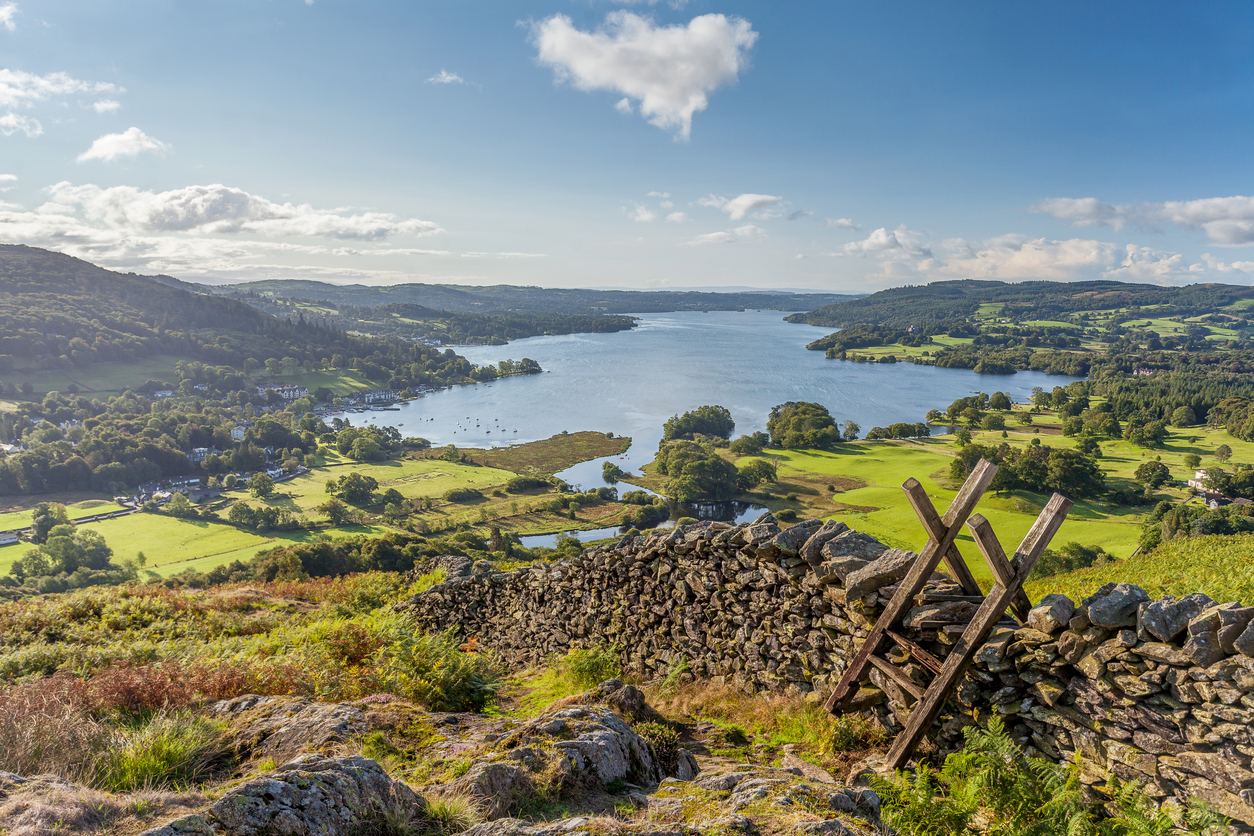 image of a cobblestone wall in the Lake District, overlooking a lake and miles of countryside