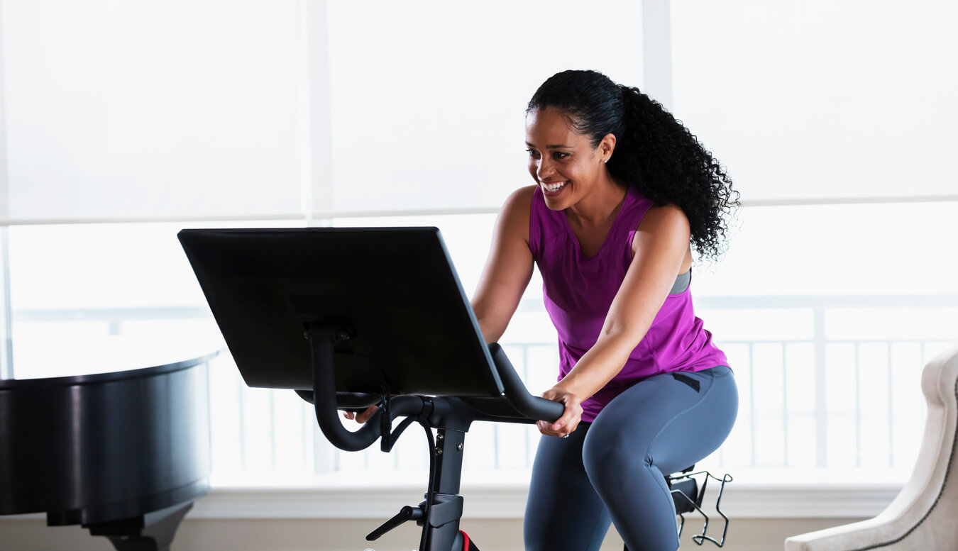 image of woman exercising on an indoor cycling bike