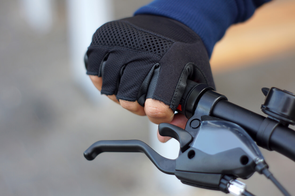 image of a cyclist's hand gripping their brakes